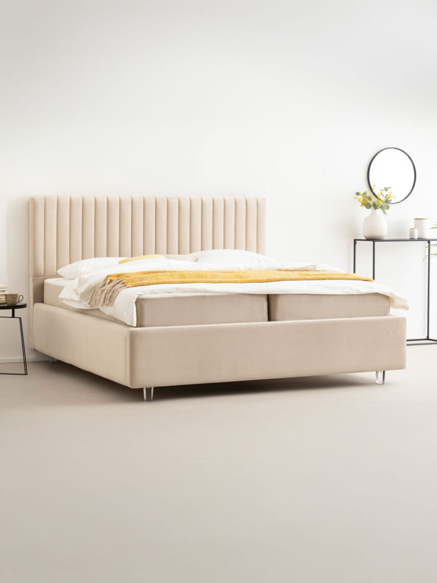 a creme-beige bed in a bedroom
